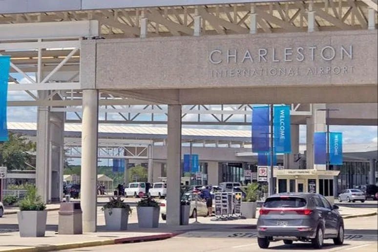 Outdoor sign for Charleston International Airport above a road