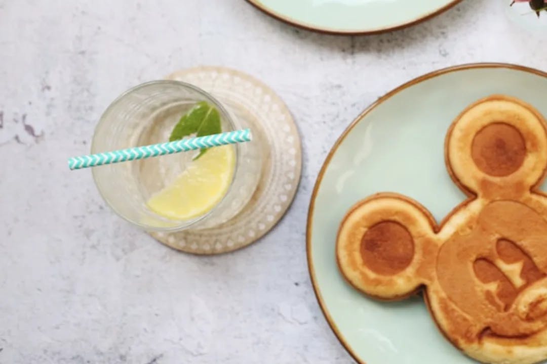 A picture of Disney pancakes with lemon water.