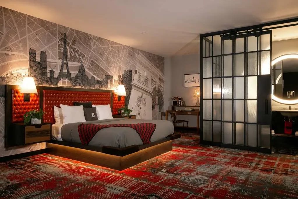 Stylish decor blending contemporary and vintage themes, a bold and moody color palette and more fill a room at Bobby Hotel