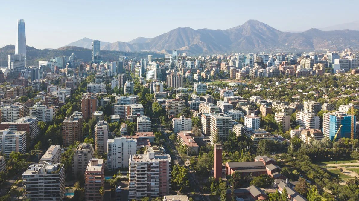 An aerial view of the city of Santiago, Chile with mountains in view.