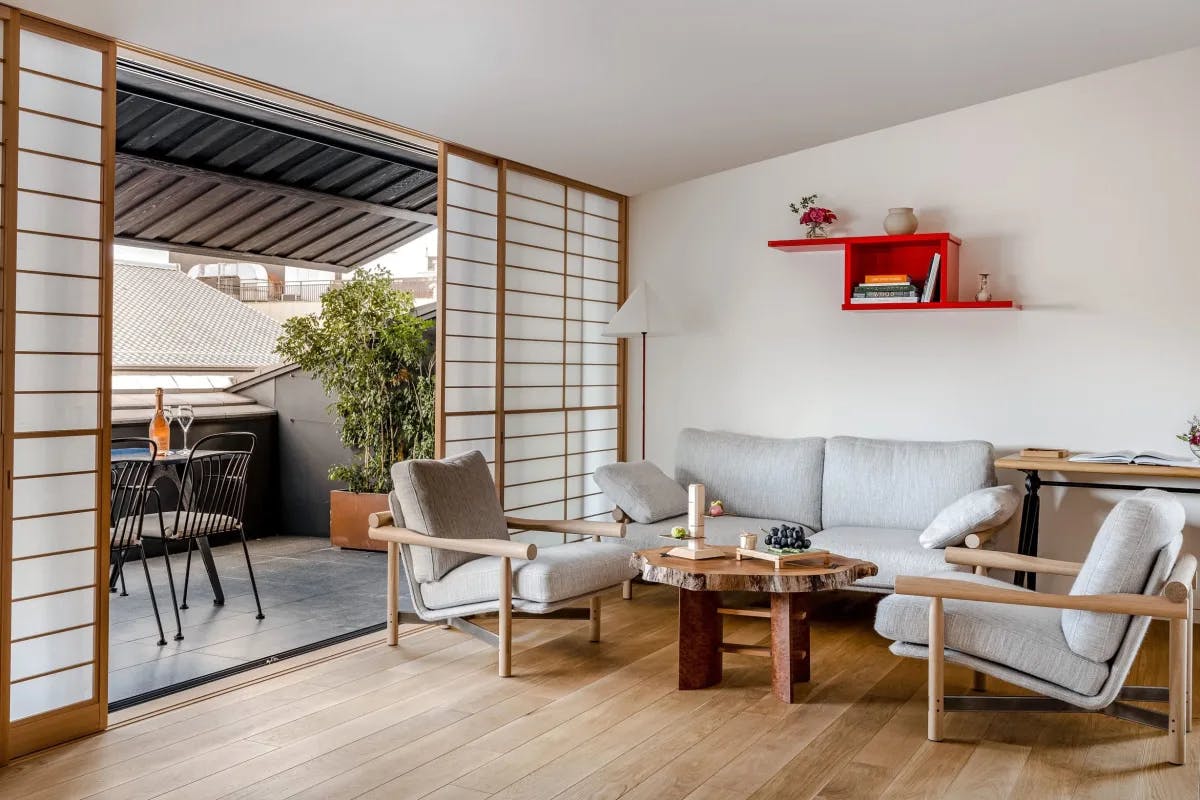 an airy living room with pale wooden floors and modern gray furniture