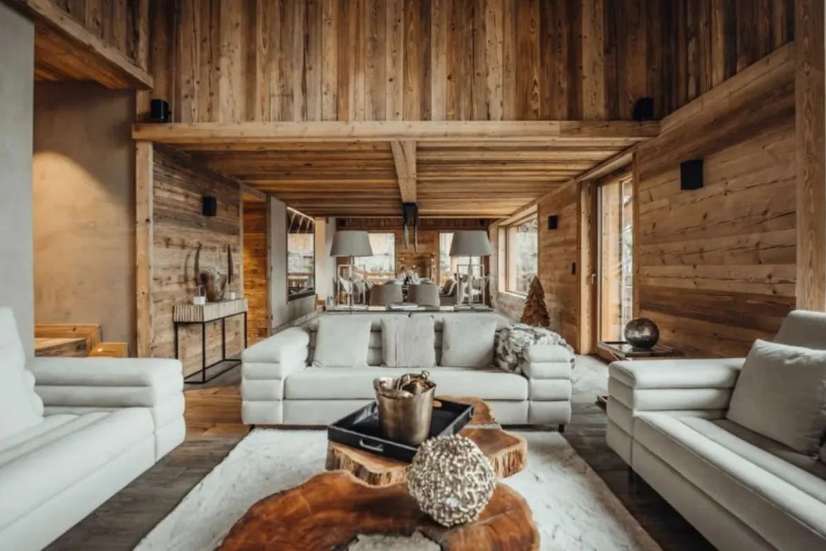 wood-paneled room with white sofas