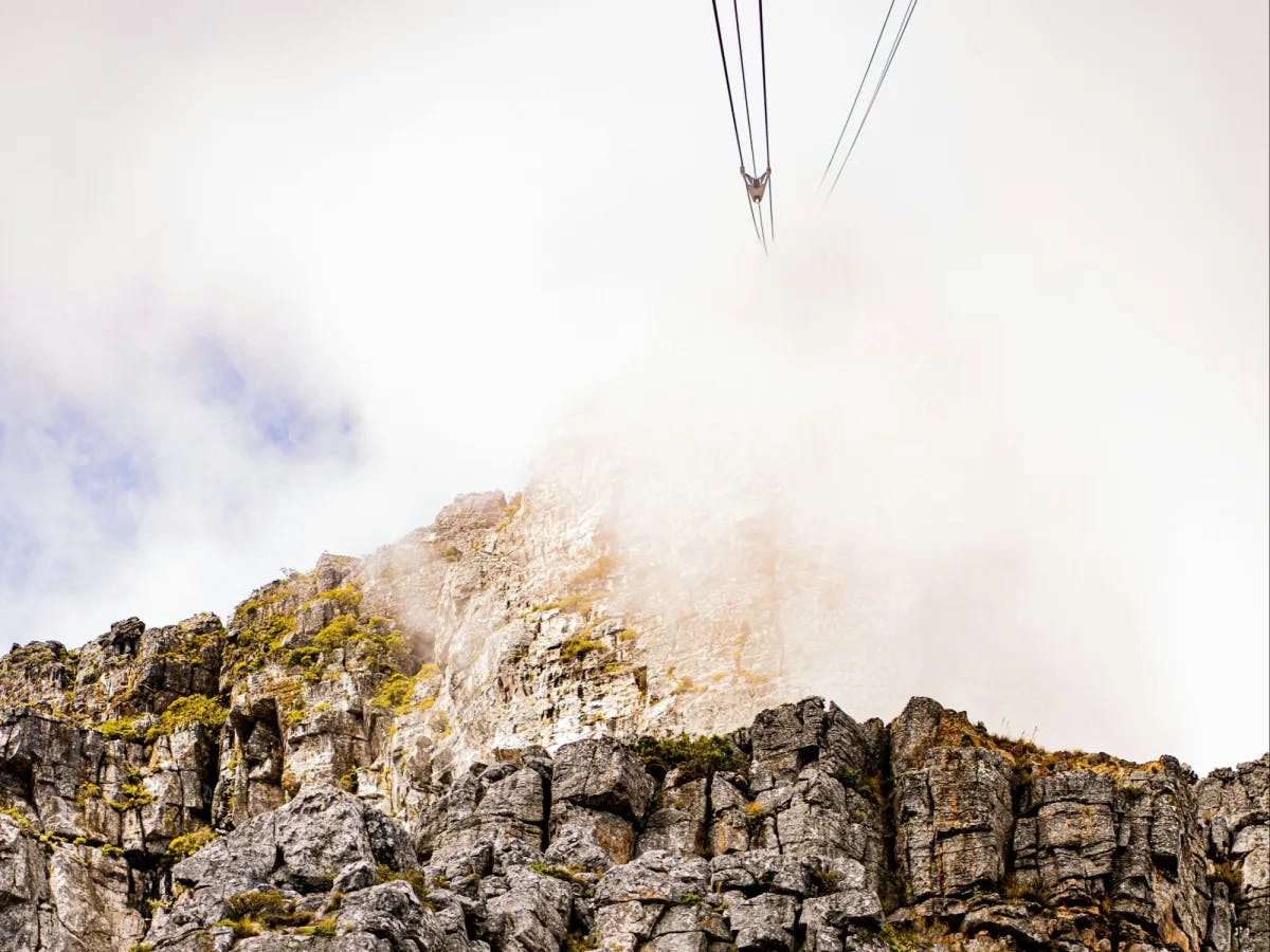 Lift going up to a rocky mountain.