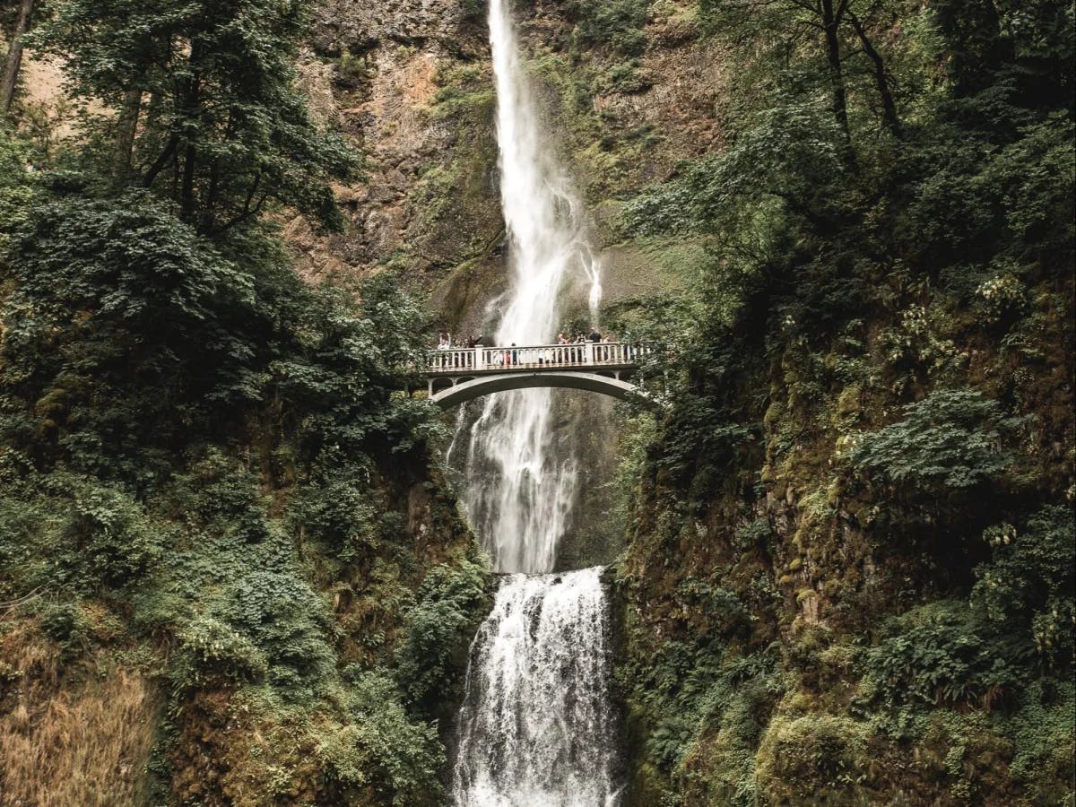 A big long waterfall on green mountains. 