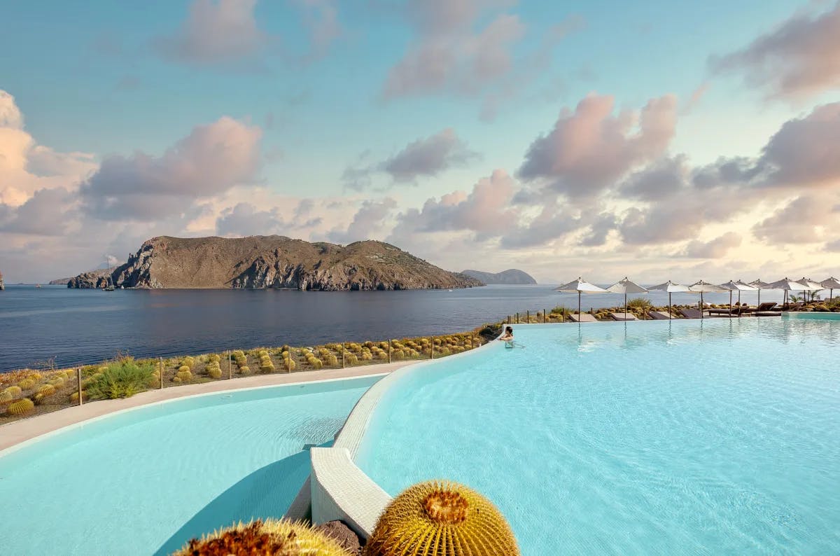 an oceanside infinity pool overlooking a rocky island