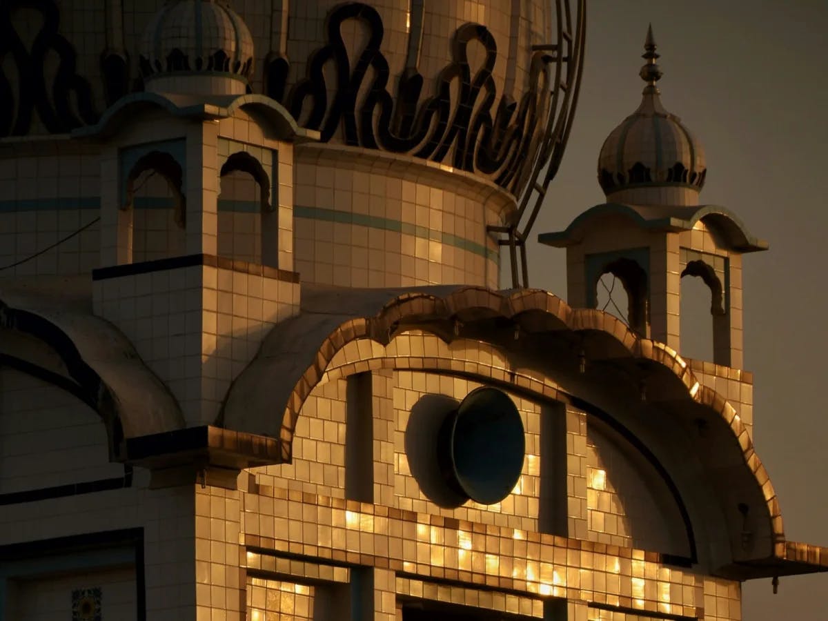 A close-up of a tiled building with a domed roof.