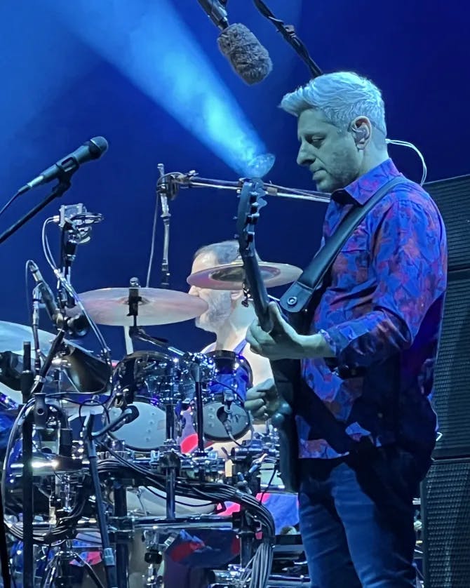 View of a guitarist performing on stage during a concert