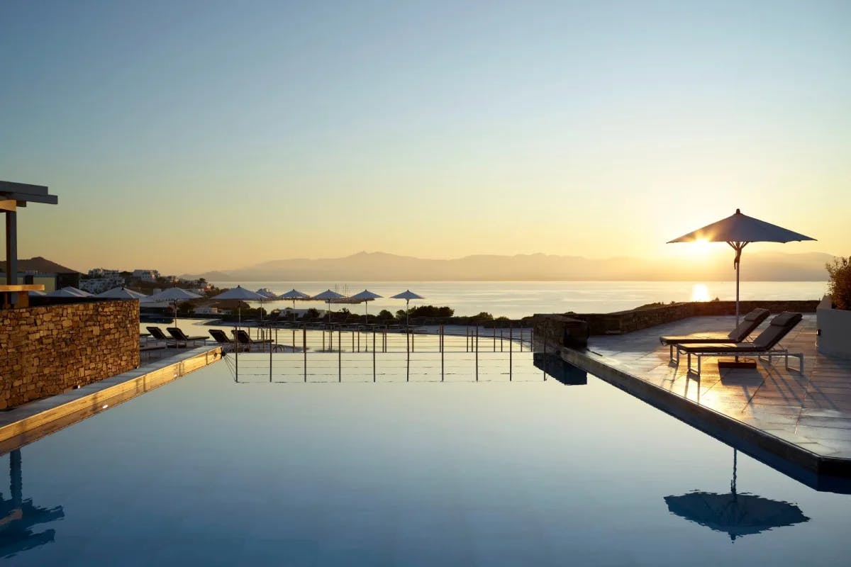 infinity pool with sunset and sea views