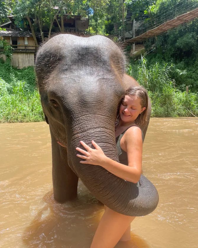 Travel advisor posing with an elephant