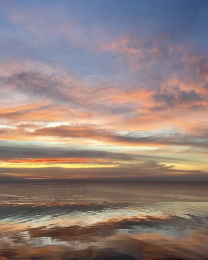 Beautiful view of sunset with orange, pink and yellow sky.