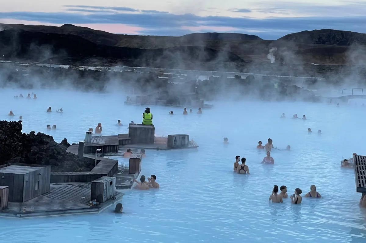 An aerial view of the geothermal spa with people in the water.