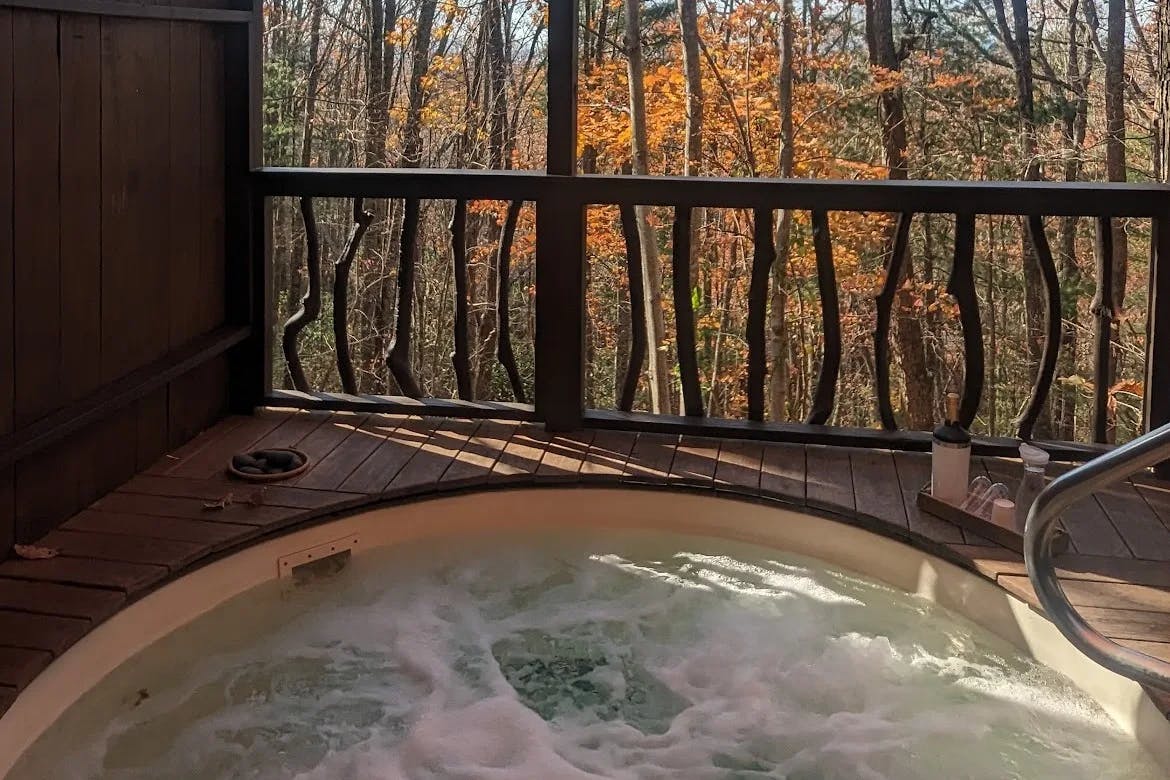 Jacuzzi with water at spa with outdoor view.  