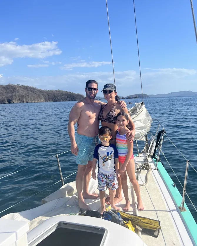 Family picture on the edge of a yacht