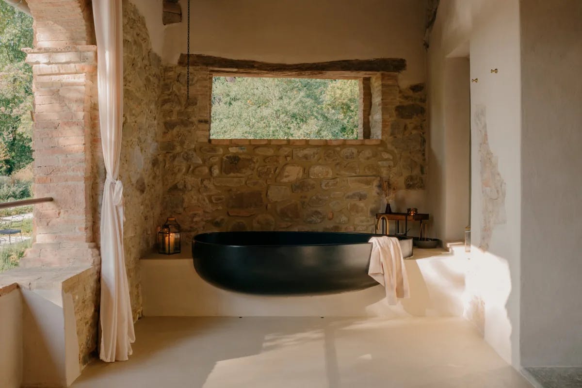 a black bathtub on a rustic terrace