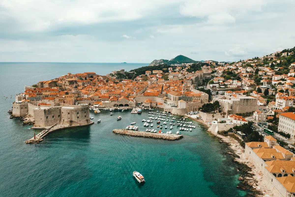 An aerial view of the city in Croatia near the turquoise blue water at daytime. 