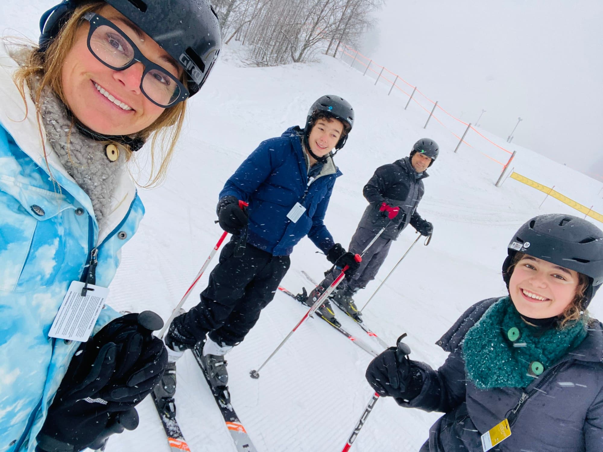 A family on skis posing for a photo