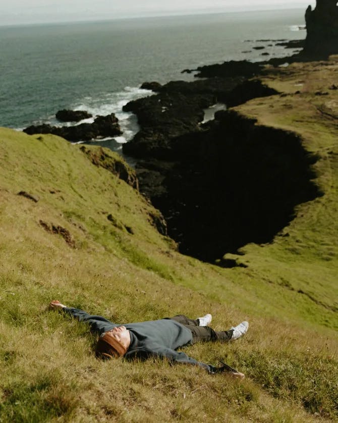 Travel advisor lying down on a beachside valley