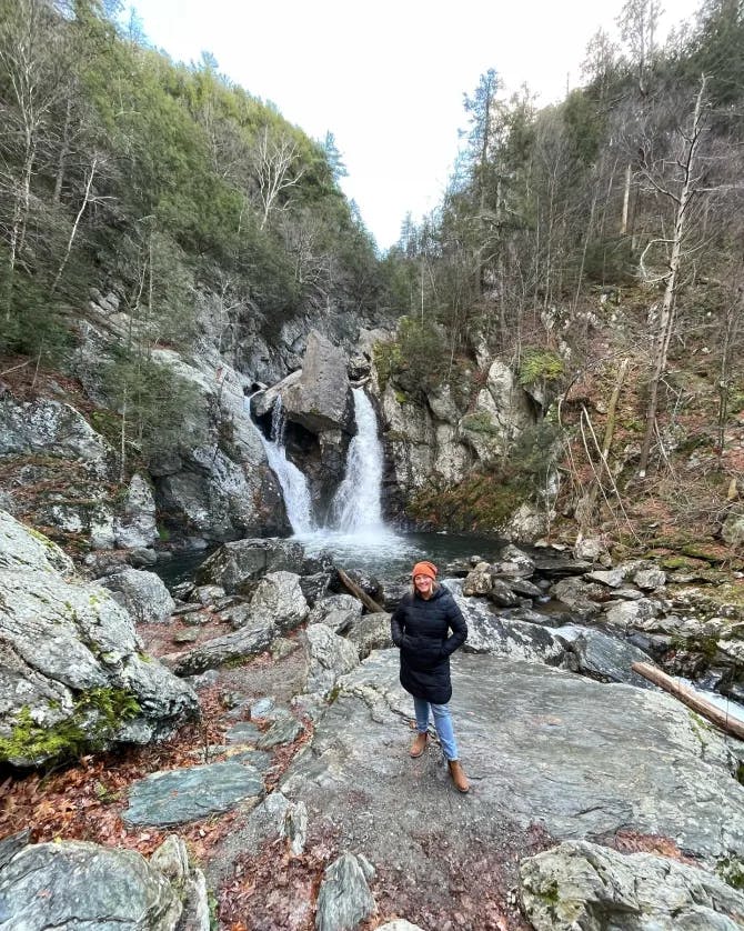 posing near waterfall in the forest