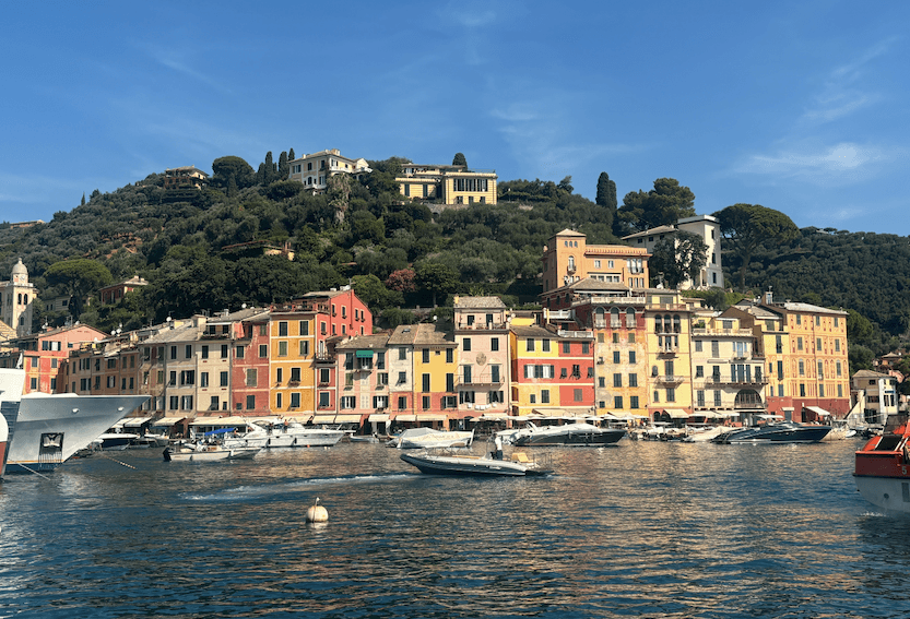 View from the water of a seas-side town full of yellow and orange buildings