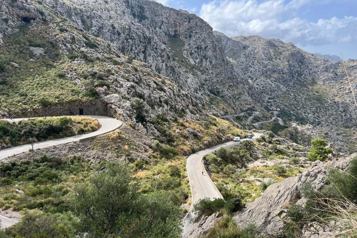 An aerial view of the mountains with cycling road on it.