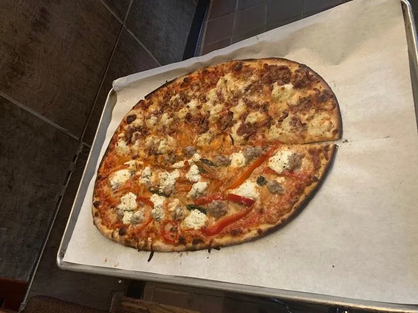 Pizza on a parchment paper-lined tray