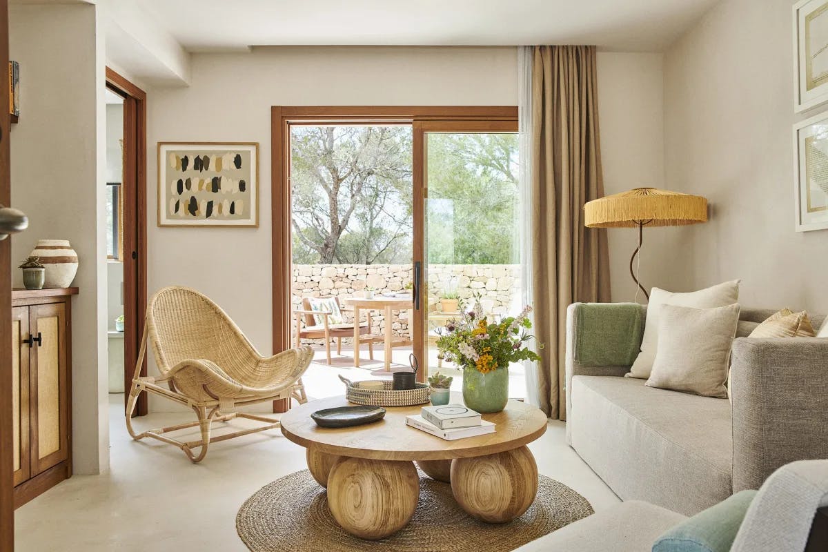 a breezy living room with wooden, natura; decor and soothing white-washed walls
