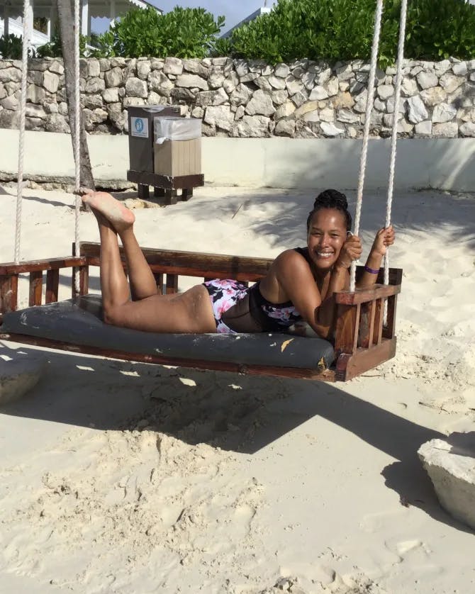 Travel advisor posing on a swing