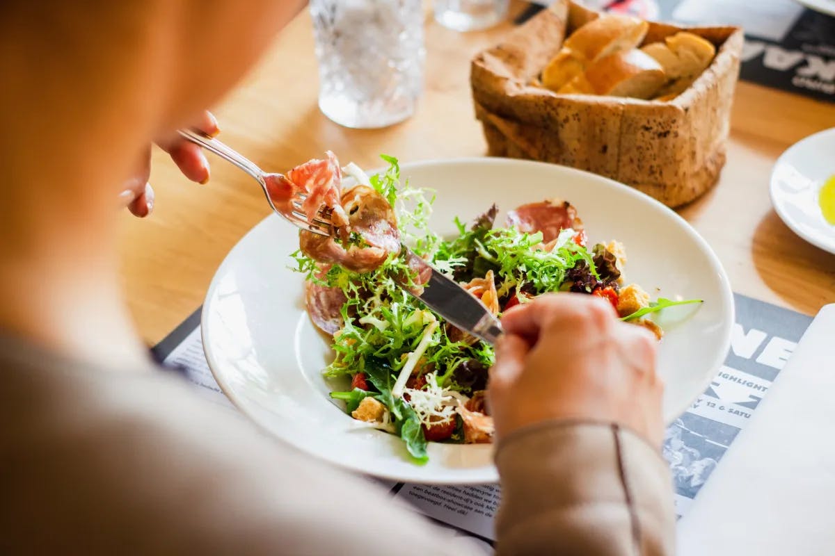 A picture of a person eating lunch at a restaurant.