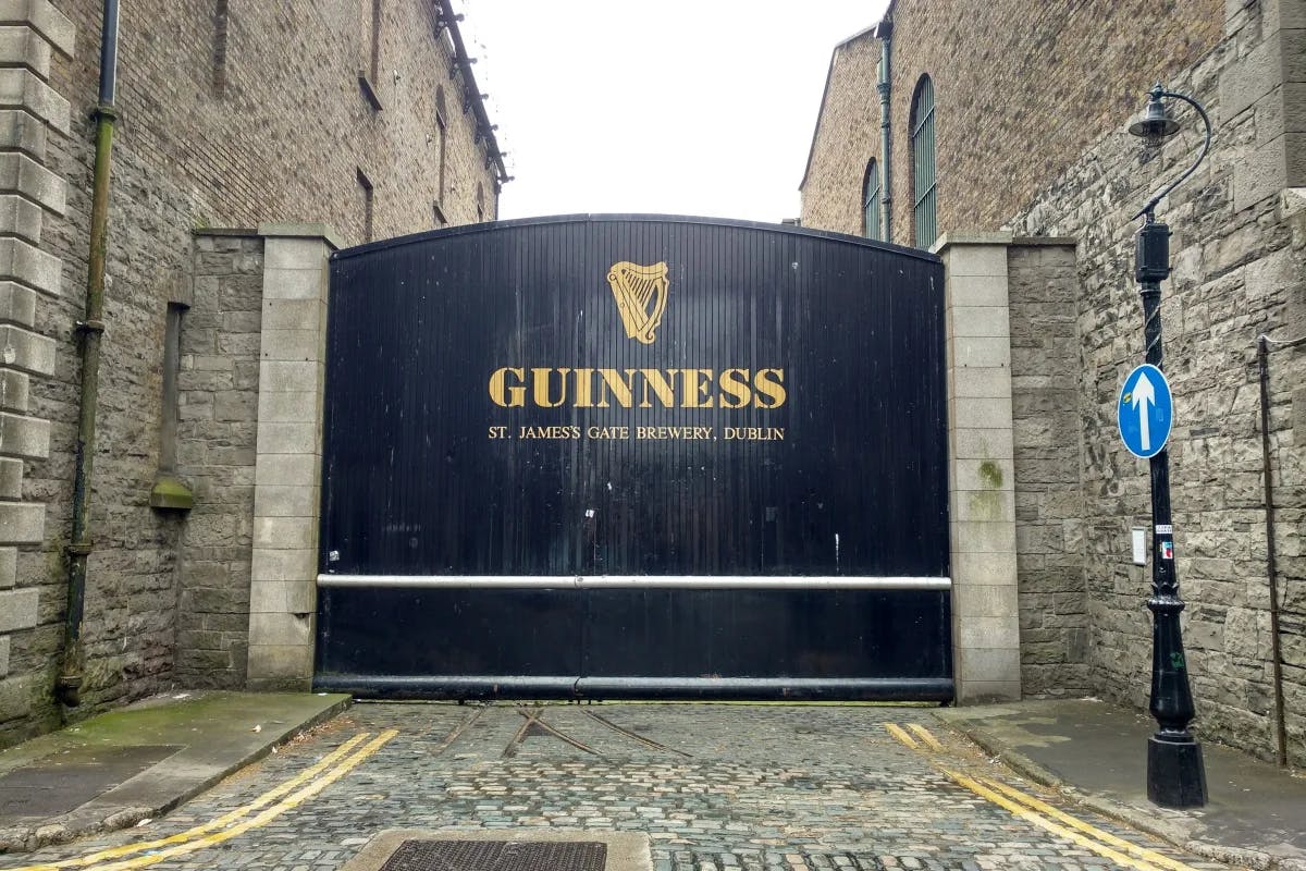A black gate with "Guinness" printed on it 