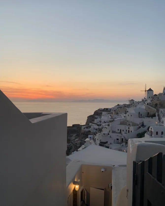 sunset view with beautiful white building and the ocean in the distance