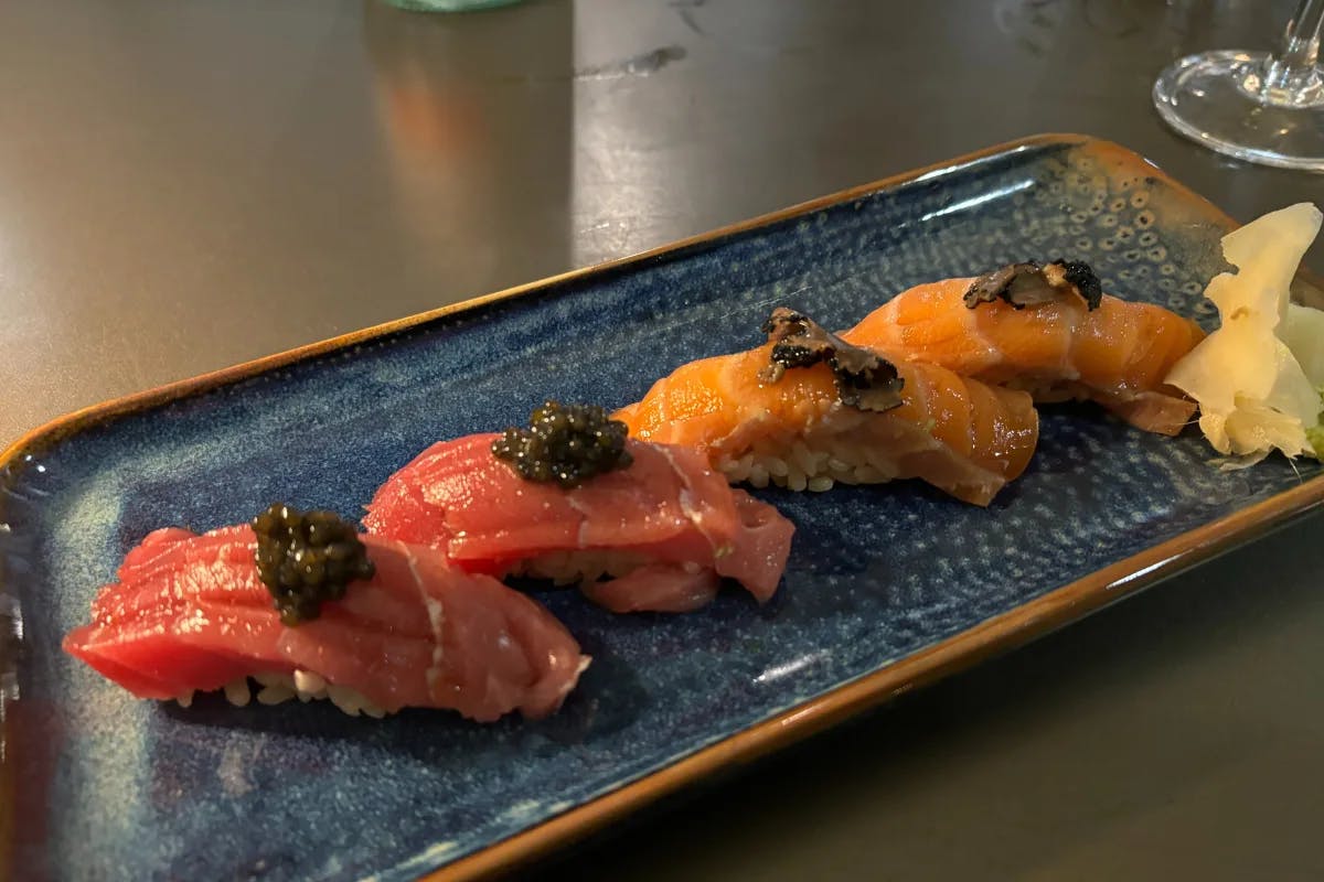 Caviar chutoro and truffle salmon nigiri plated beautifully at Kissaki on a slate countertop.