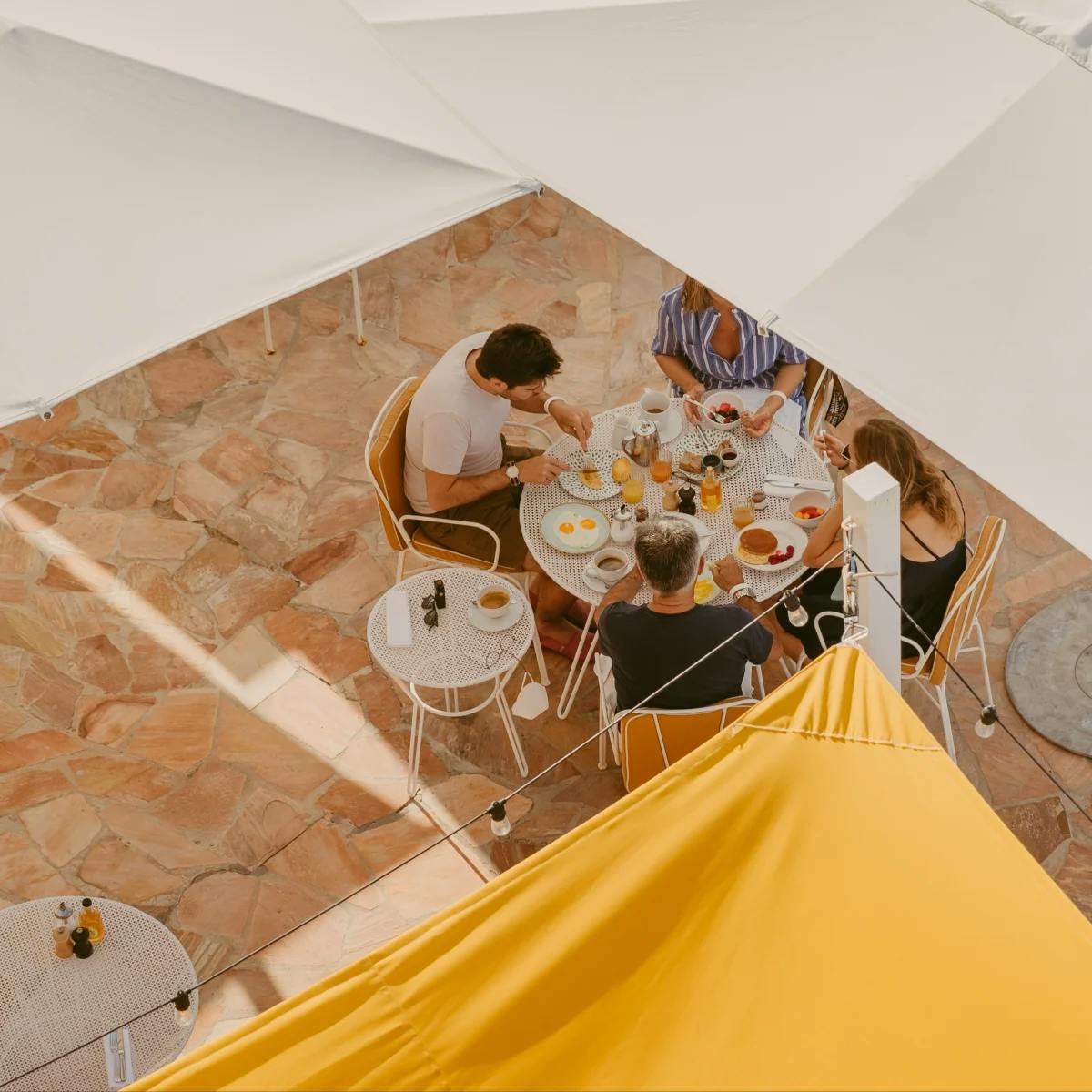 aerial view of people eating at a round outdoor table