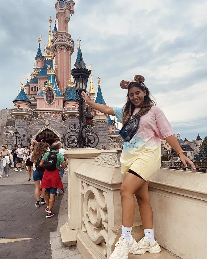 Travel advisor posing in front of Disney land
