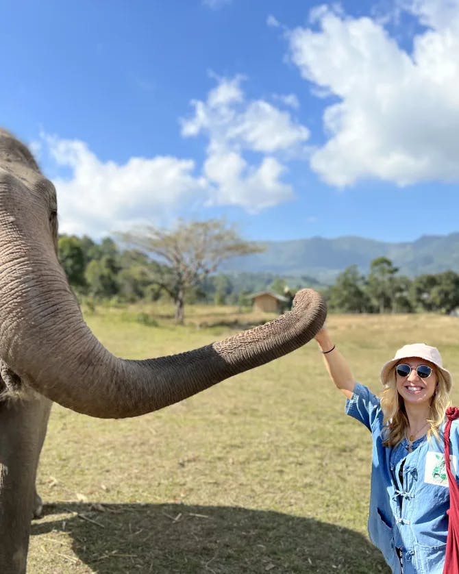 Woman posing with an elephant