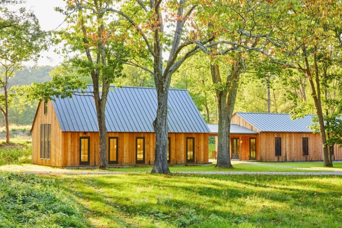 exterior of modern barn surrounded by green spring landscape