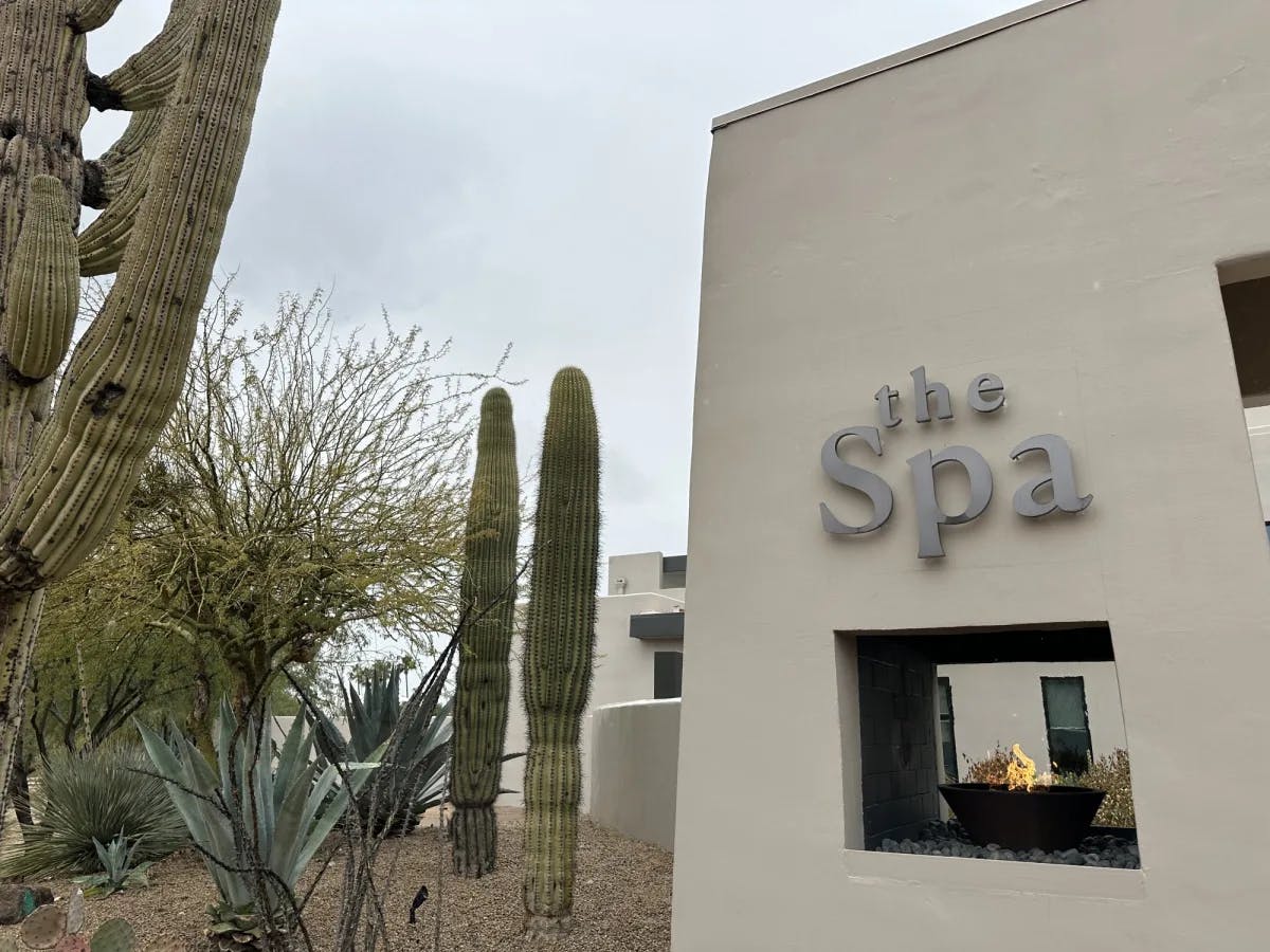 The Spa written on building with cactus trees on side.