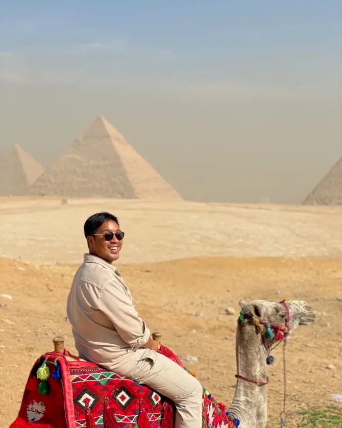 Travel advisor sitting on camel