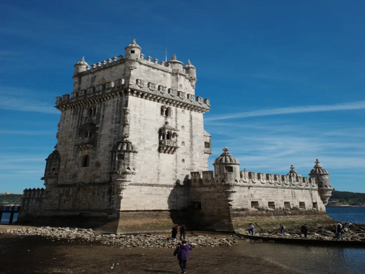 An ancient castle-like building on a beach