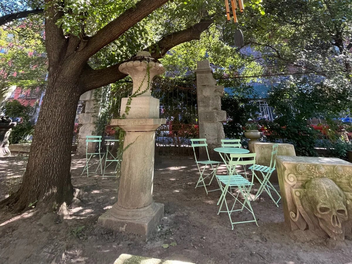 A picture of an old monument covered with a big tree.