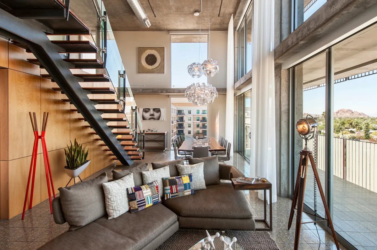 a colorful loft with eclectic artwork and a trio of globe-shaped chandeliers