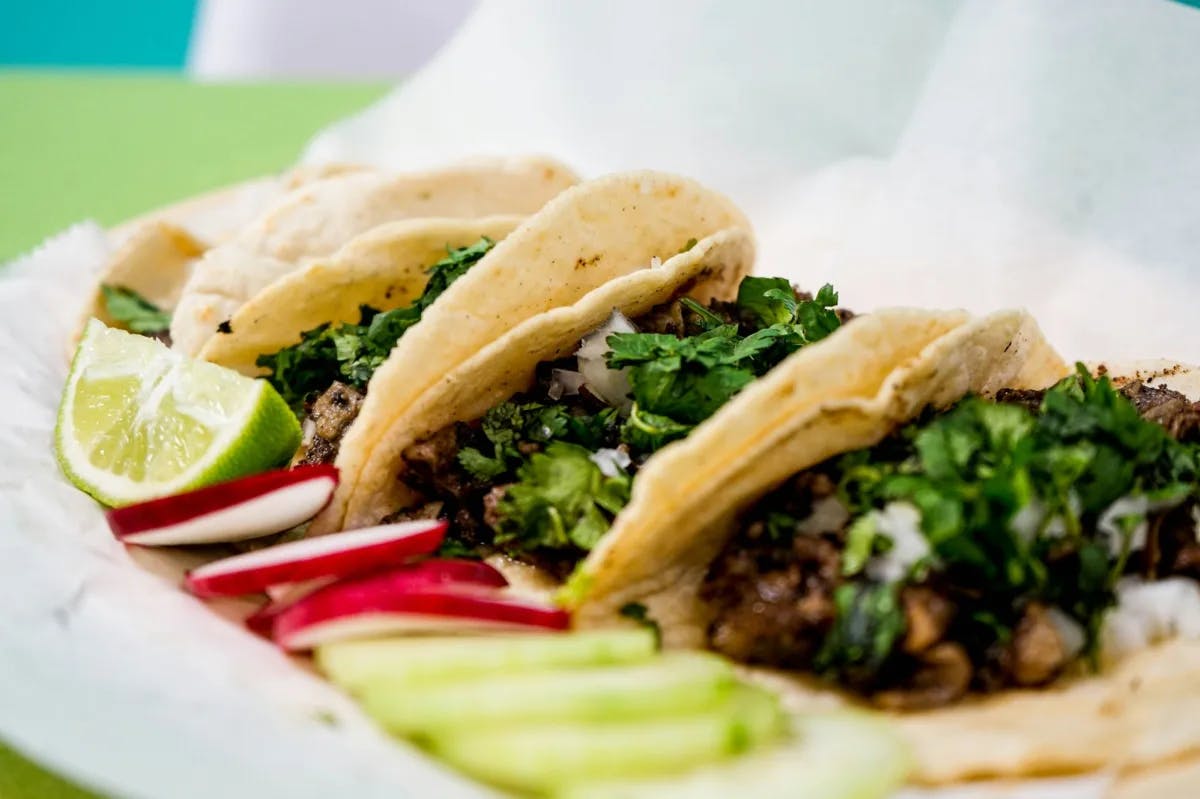 Three tacos on a plate.