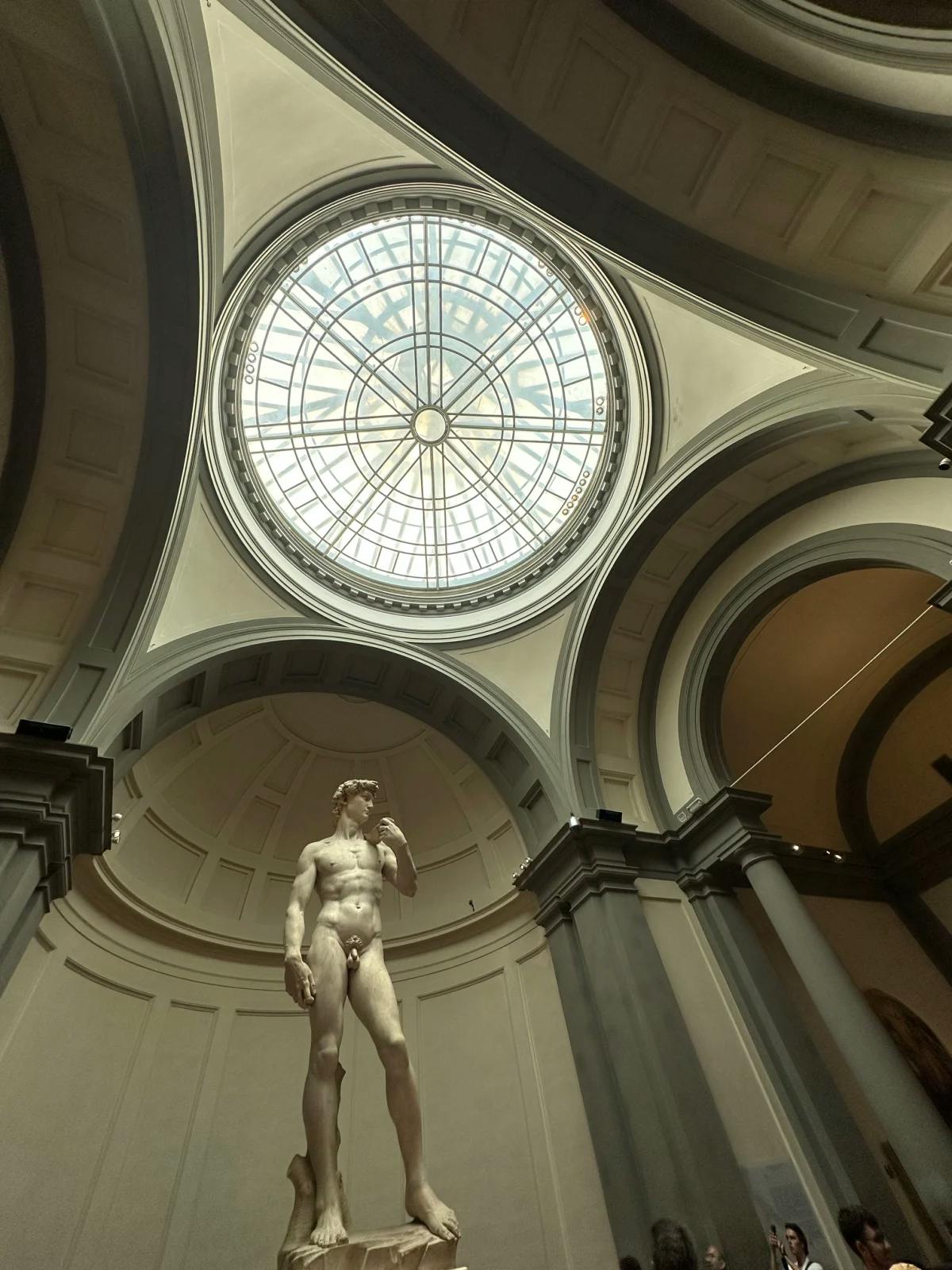 Statue of a naked man inside a building.