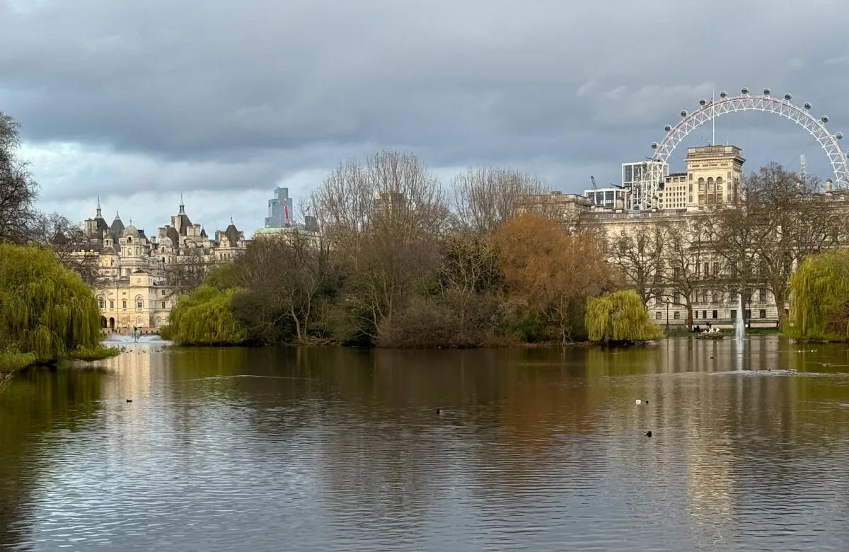 A picture of the city from the water with the London Eye in the back.