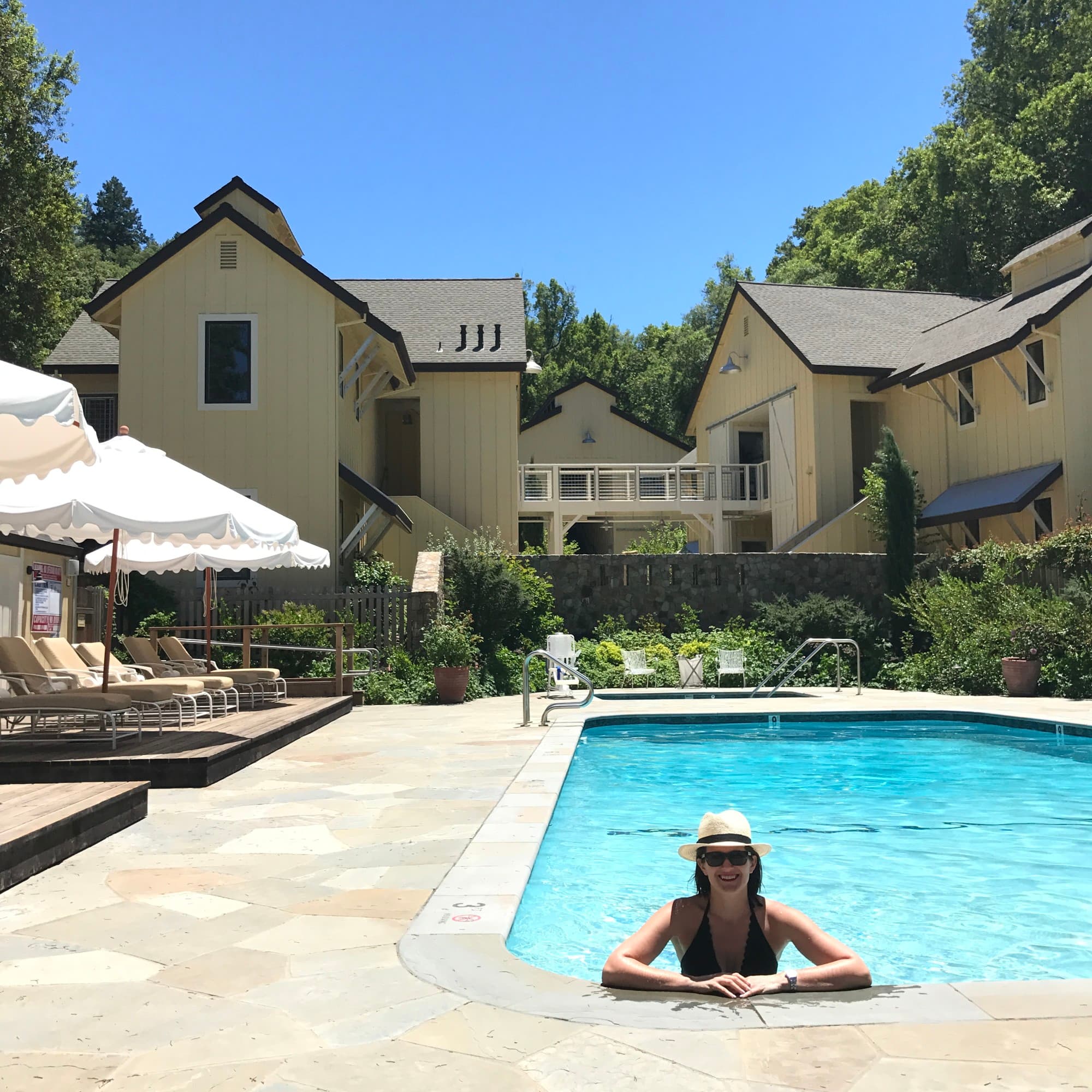 Travel advisor posing in a pool