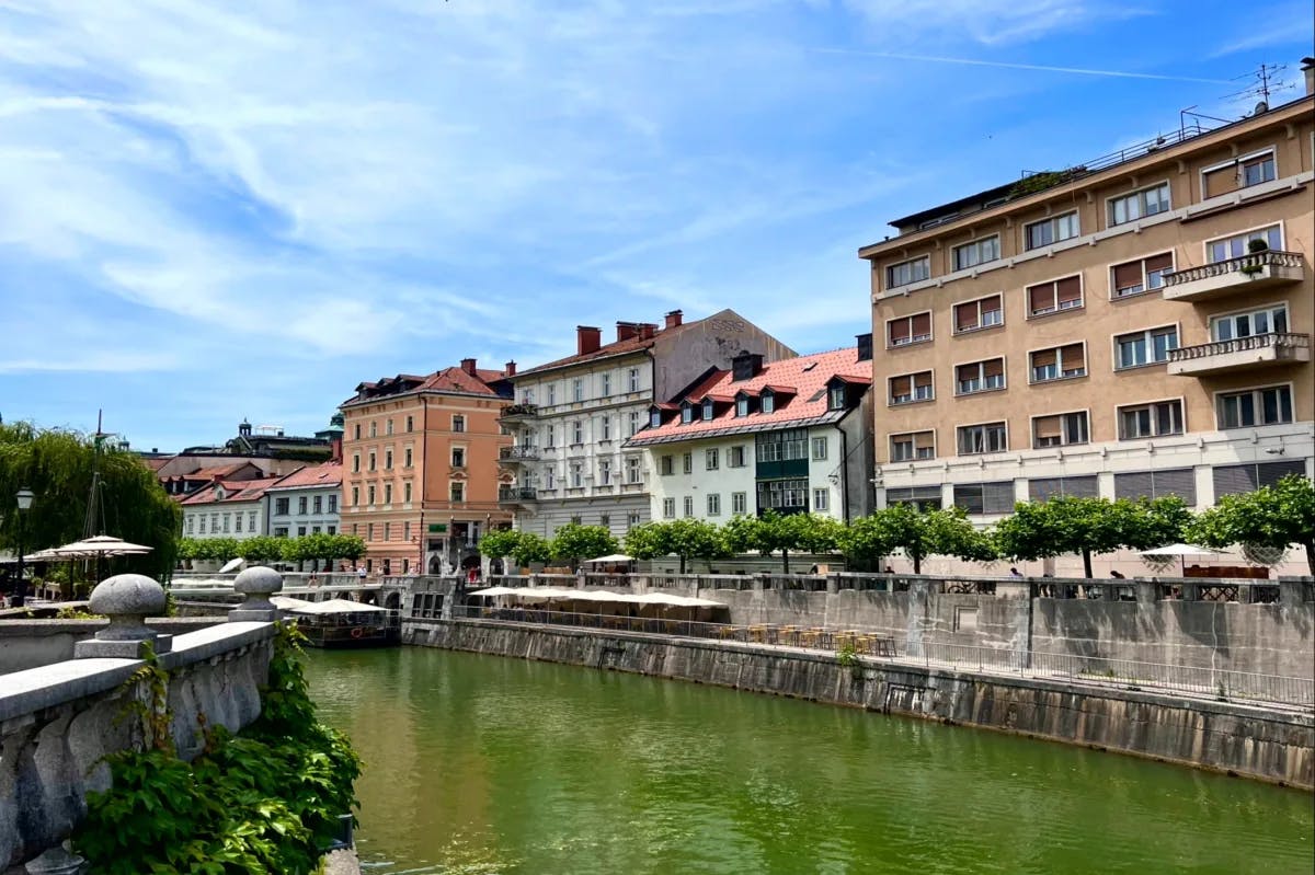 A far view of the multiple buildings on a canal of water during the daytime.