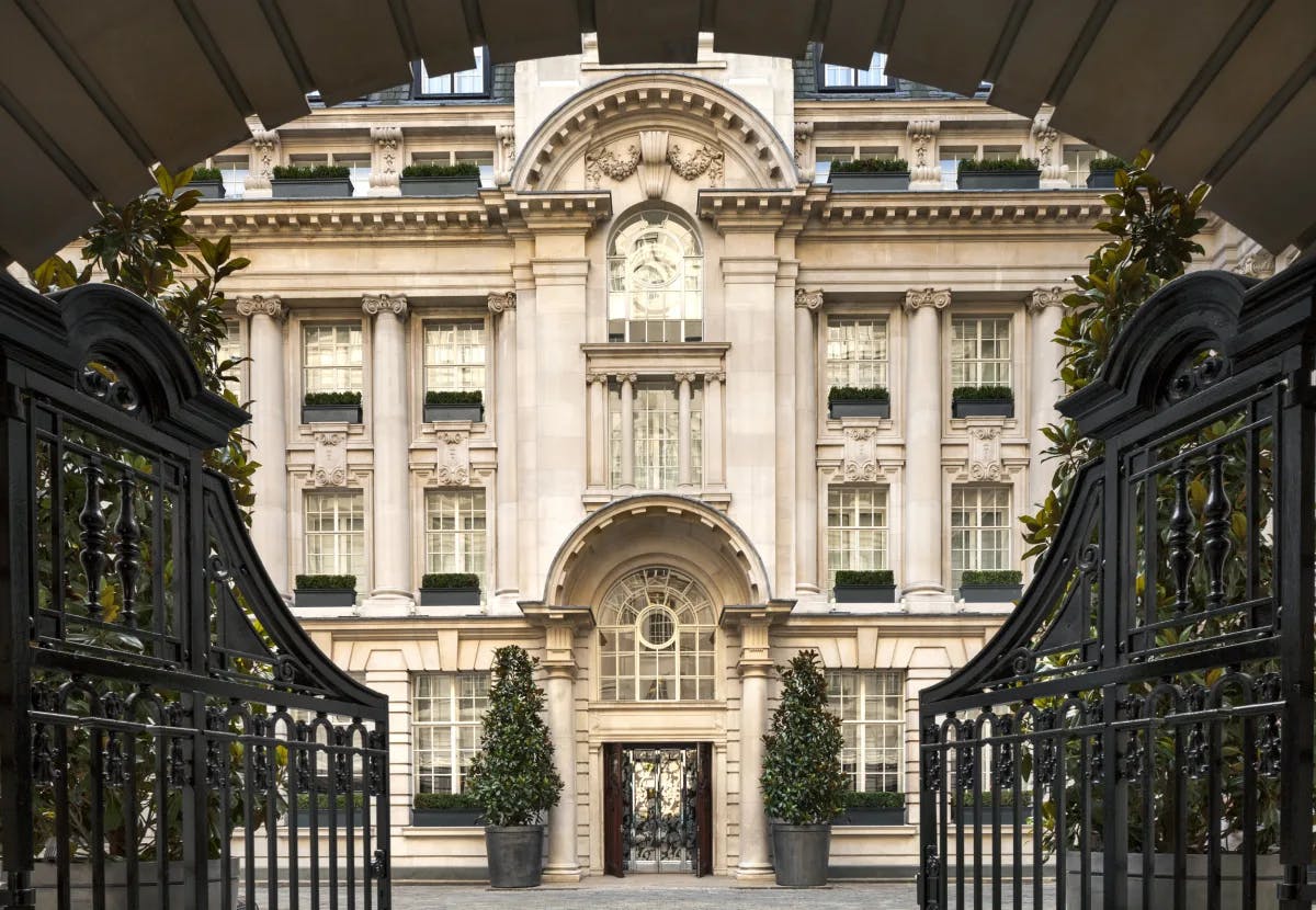 Grand entrance gates opening to courtyard and building of Rosewood London.