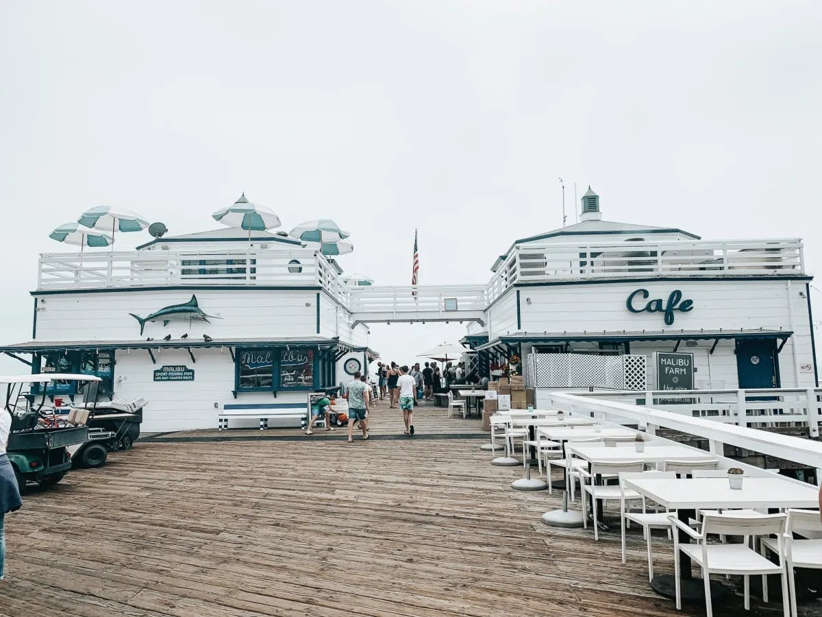 Group of people on a wooden pier on a cloudy day.