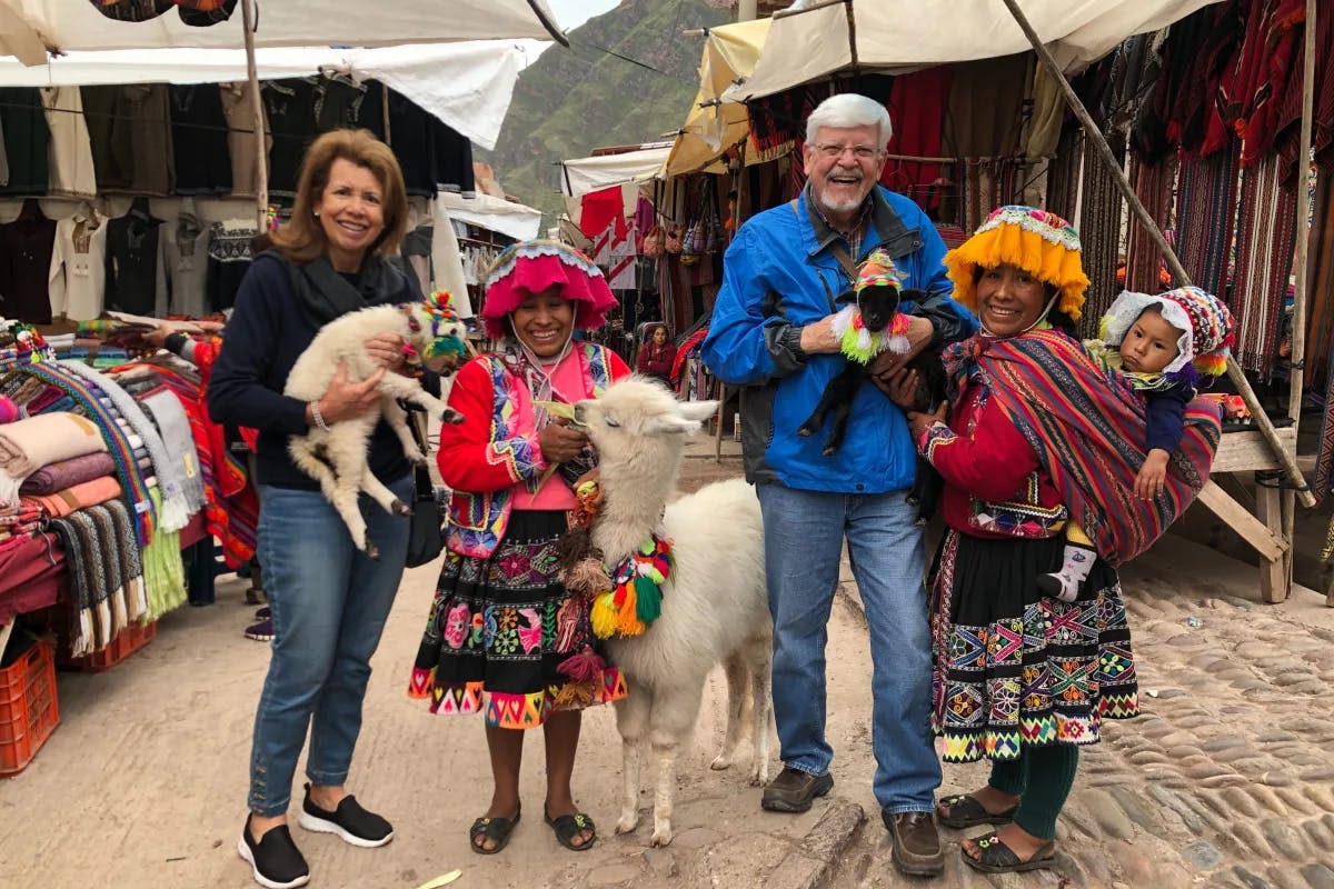 Souvenir photo with the women and animals in Pisac Market.