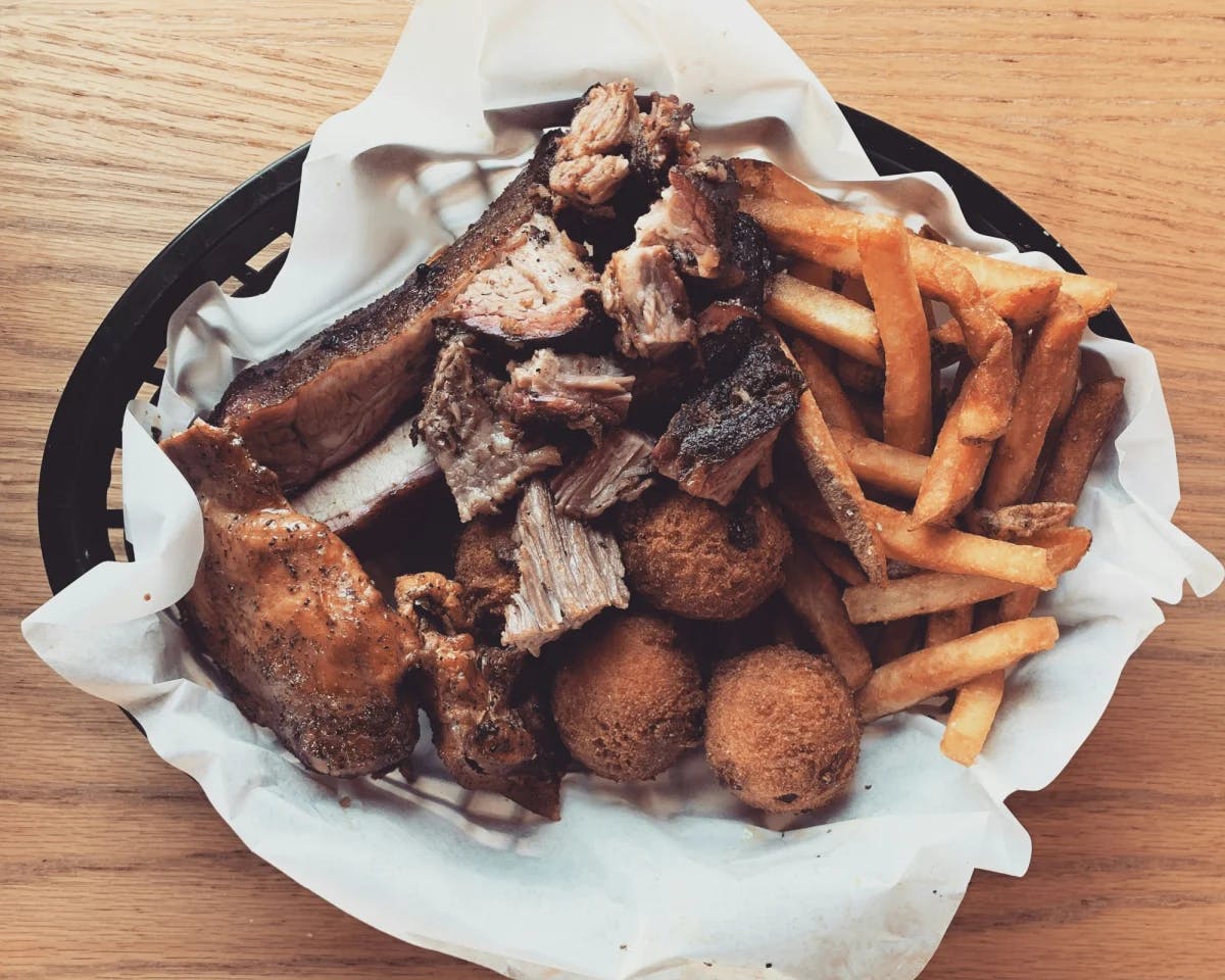 Fries, steak and meat balls in a basket.