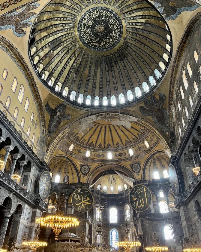 A view inside of Hagia Sophia (meaning Holy Wisdom in Greek), showcasing the Byzantine domes of this holy house of worship.